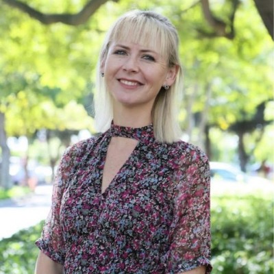 Portrait of Dr Leigh Adams Tucker outdoors beneath trees